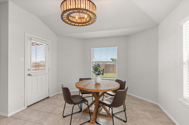 Dining area with plenty of natural light, and a chandelier | Image 13