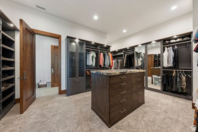 Spacious closet with light colored carpet | Image 33