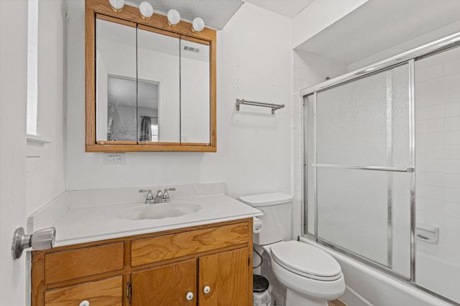 Full bathroom with vanity and bath / shower combo with glass door | Image 25