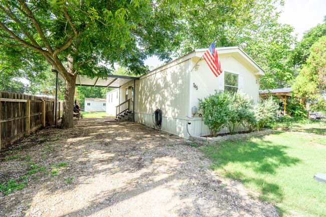 View of home's exterior with entry steps and driveway | Image 4