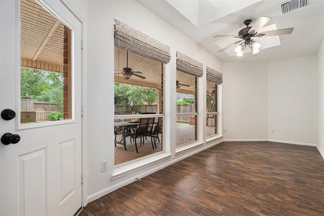 Just off the primary suite is this charming sunroom! Maybe it could be another home office, yoga studio, library, music room or just a place for the family to chill after a long day in your backyard oasis! | Image 16
