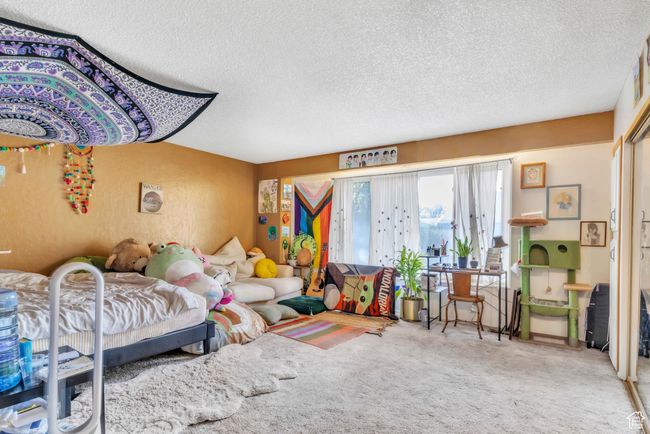 Carpeted bedroom featuring a textured ceiling | Image 20