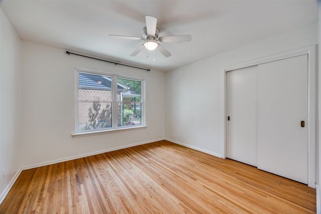 Unfurnished bedroom with light wood finished floors, a closet, and a ceiling fan | Image 7