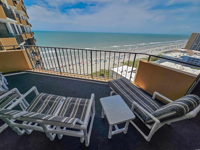 Balcony with view of water and beach | Image 4