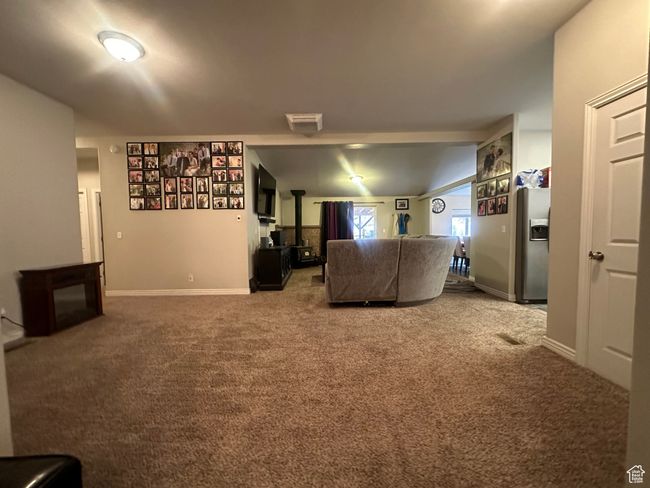 Unfurnished living room with carpet flooring, baseboards, and visible vents | Image 5