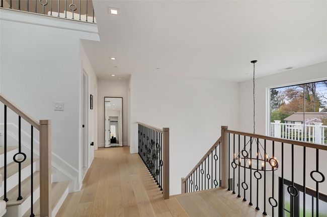 Hallway featuring baseboards, recessed lighting, an upstairs landing, a chandelier, and wood finished floors | Image 29