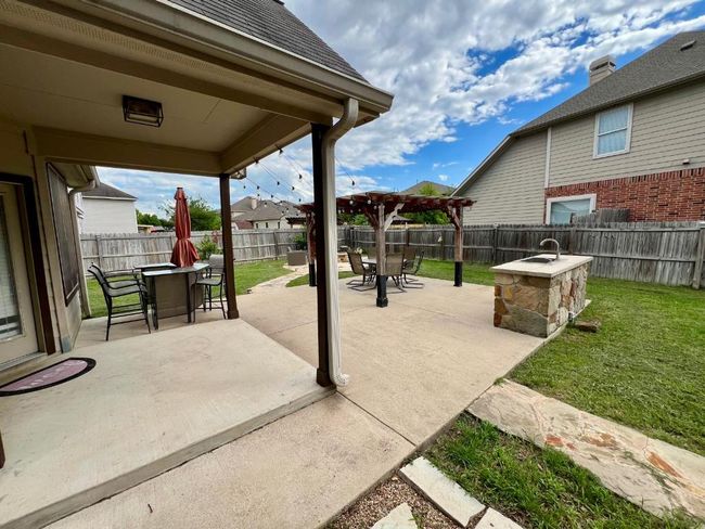 Fenced backyard with outdoor dining area, a patio, and a pergola | Image 15