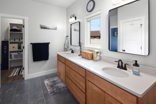 Primary bathroom offers 2 sinks & access to laundry. | Image 38