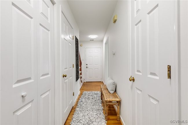 Downstairs hallway with half bath, laundry and deep storage closet. | Image 20
