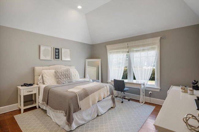 Bedroom featuring baseboards, wood finished floors, vaulted ceiling, and recessed lighting | Image 28