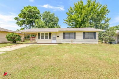 Ranch-style house with a carport and a front yard | Image 2