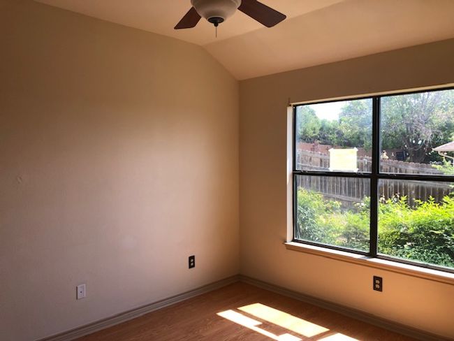 Bedroom featuring wood finished floors, ceiling fan, lofted ceiling, and baseboards | Image 12
