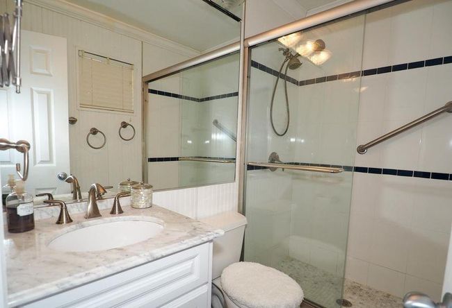 Bathroom with vanity, crown molding, toilet, and a shower stall | Image 7