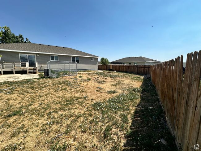 Fenced backyard with a deck | Image 26