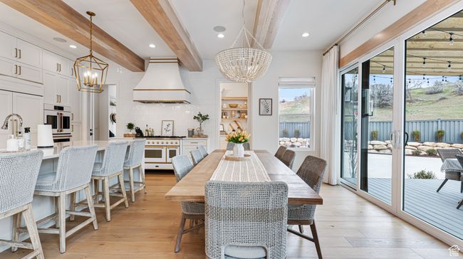 Dining area featuring recessed lighting, an inviting chandelier, beamed ceiling, and light wood-type flooring | Image 20