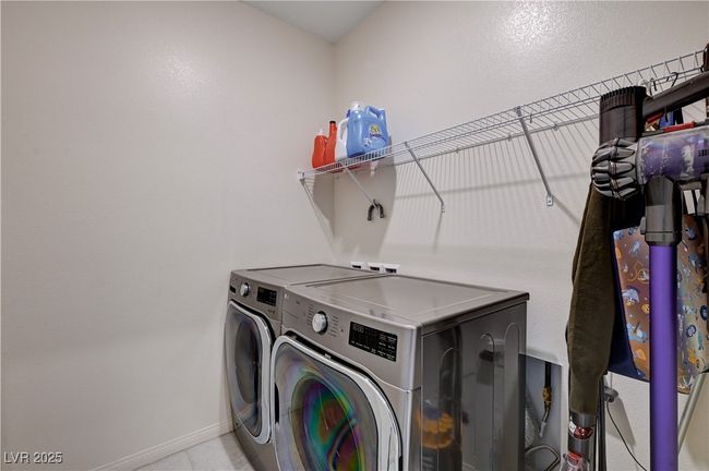 Laundry area featuring washer and dryer and baseboards | Image 25
