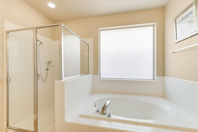 Bathroom with a garden tub, a shower stall, and recessed lighting | Image 13