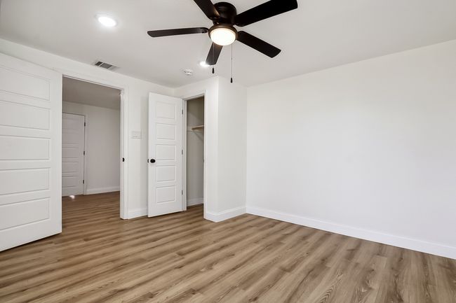 Unfurnished bedroom featuring a closet, wood finished floors, visible vents, and baseboards | Image 14