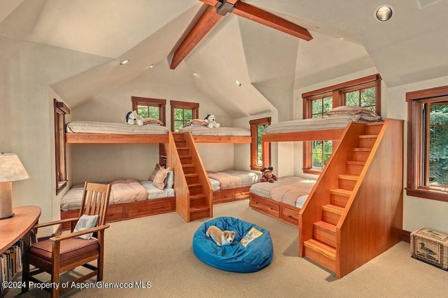 4th bedroom, filled with light from three walls of windows. Three of the beds are queens, 3 XL. | Image 42