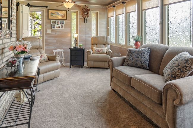 Living room with carpet, a ceiling fan, and a wealth of natural light | Image 25