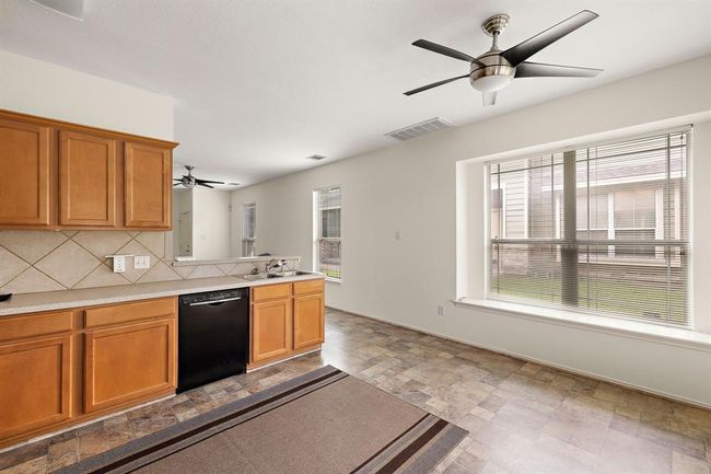 Functional kitchen with generous counter space, perfect for meal prep and hosting. | Image 9
