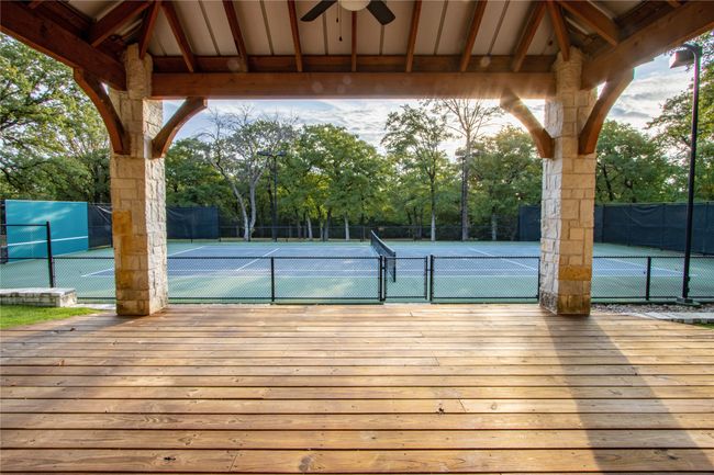 View of tennis court with a gazebo and fence | Image 34