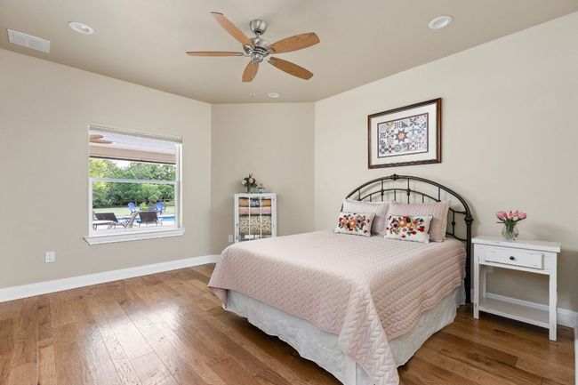The guest bedroom offers generous natural light and a spacious walk-in closet for added comfort. | Image 21