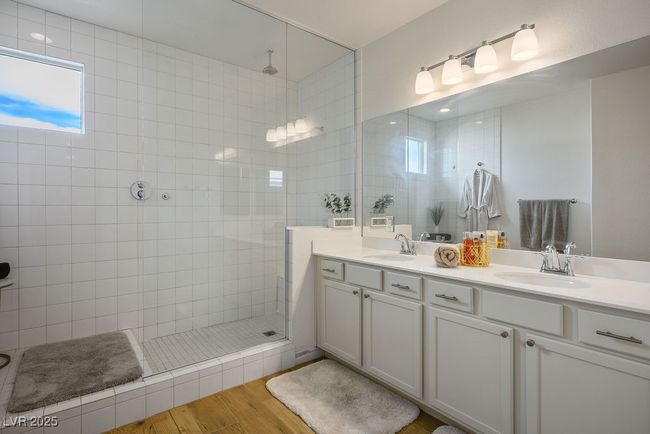 Full bathroom featuring double vanity, a sink, a walk in shower, and wood finished floors | Image 23