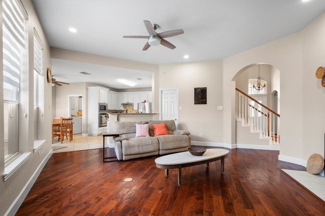 Living area with ceiling fan, stairway, wood-type flooring, arched walkways, and recessed lighting | Image 14