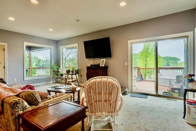 Carpeted living room with recessed lighting, baseboards, visible vents, and plenty of natural light | Image 9