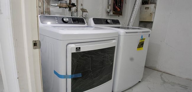 Washroom featuring marble finish floor, laundry area, and washer and clothes dryer | Image 49