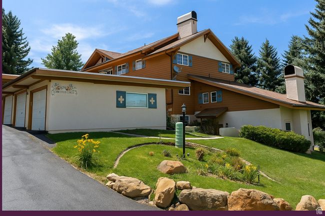 View of side of home with a chimney, a lawn, and stucco siding | Image 24