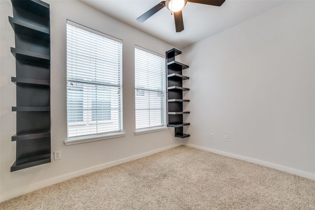 Carpeted spare room featuring baseboards, ceiling fan, and a healthy amount of sunlight | Image 13