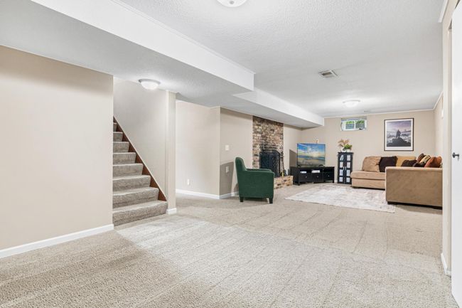 The lower level features another wood burning fireplace and plenty of room for relaxing, entertaining, office space, a children's play area, and much more. | Image 14