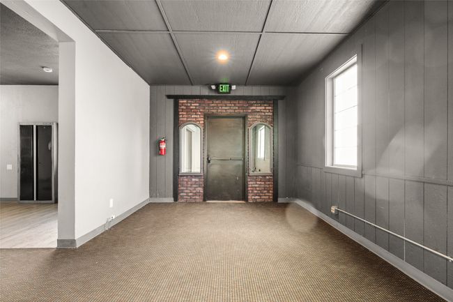 Carpeted empty room featuring wood walls | Image 42