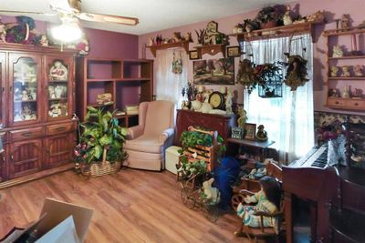 Living room featuring ceiling fan and hardwood / wood-style flooring | Image 3