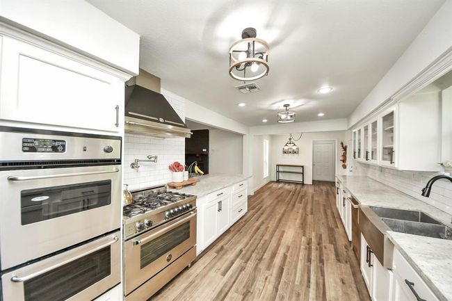 Spacious and inviting—this view from the kitchen flows into a sunny breakfast area with room for a large table to gather around. | Image 13