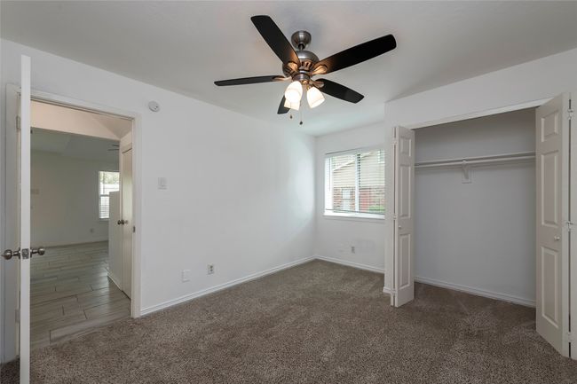 Unfurnished bedroom with multiple windows, baseboards, and carpet floors | Image 12