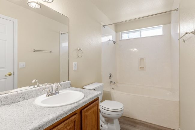 Full bathroom featuring shower / washtub combination, wood finished floors, and vanity | Image 19