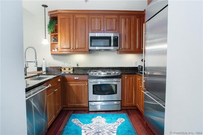 Kitchen w/SS appliances and Breakfast bar. | Image 7