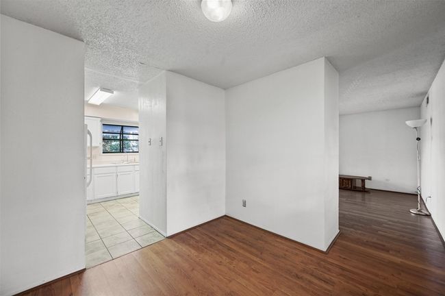 Unfurnished room featuring a textured ceiling and wood finished floors | Image 6