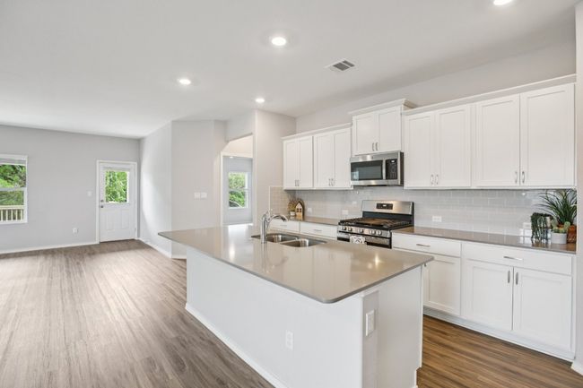 Nice floor plan for entertaining inside and outside. The living areas flow out on to the covered patio and deck. | Image 11