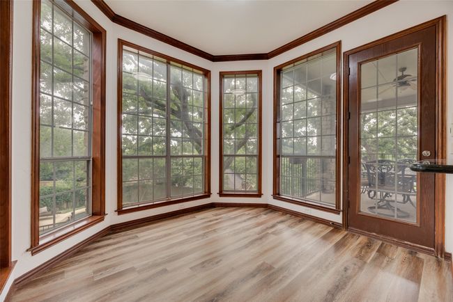 Breakfast nook features a bay of windows overlooking the backyard. | Image 9