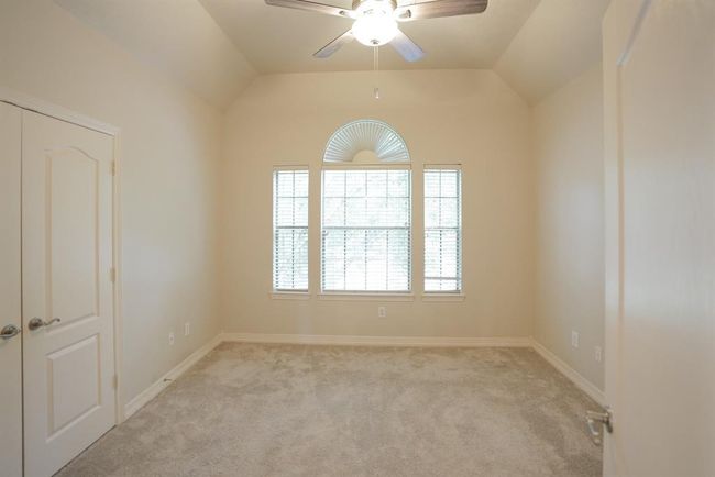 The fourth bedroom offers lots of natural light, soft neutral tones and a good size closet. | Image 33