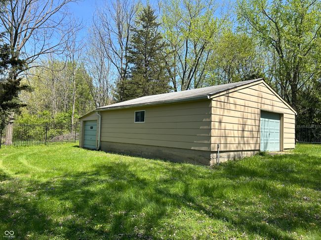 Additional huge garage in back of property. 1 car door, but fits 4 vehicles, with an additional add on in back of building. | Image 6