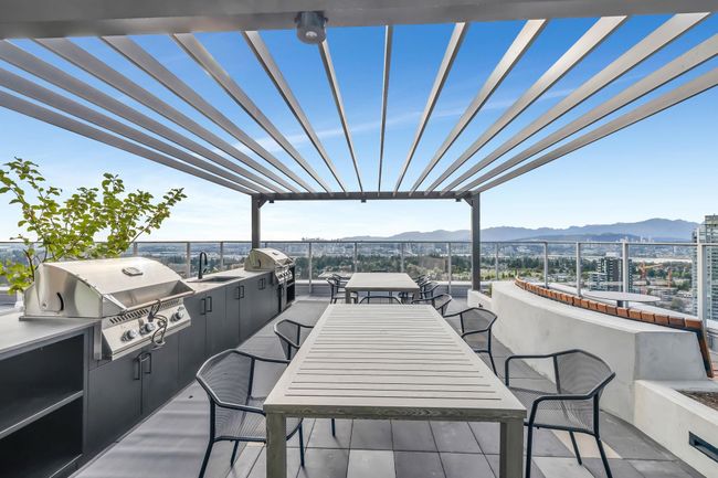 View of patio with a mountain view, an outdoor kitchen, and outdoor dining space | Image 27