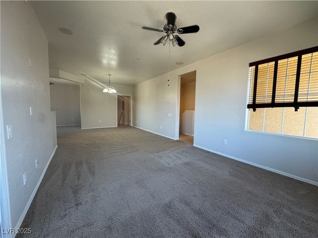 Carpeted spare room with baseboards and a ceiling fan | Image 5