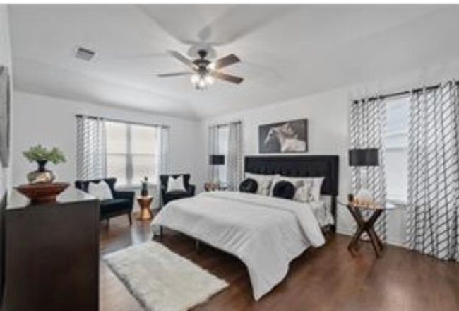 Bedroom featuring wood finished floors, ceiling fan, and visible vents | Image 14