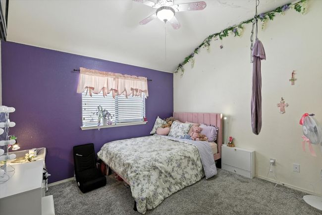 Bedroom with lofted ceiling, carpet flooring, and a ceiling fan | Image 14