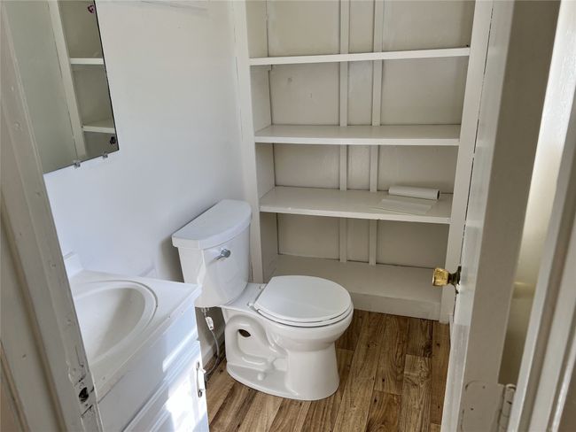 Bathroom featuring toilet, vanity, and wood finished floors | Image 10